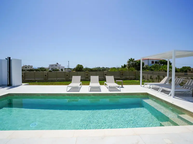 Pool terrace and lawn with the mountains behind