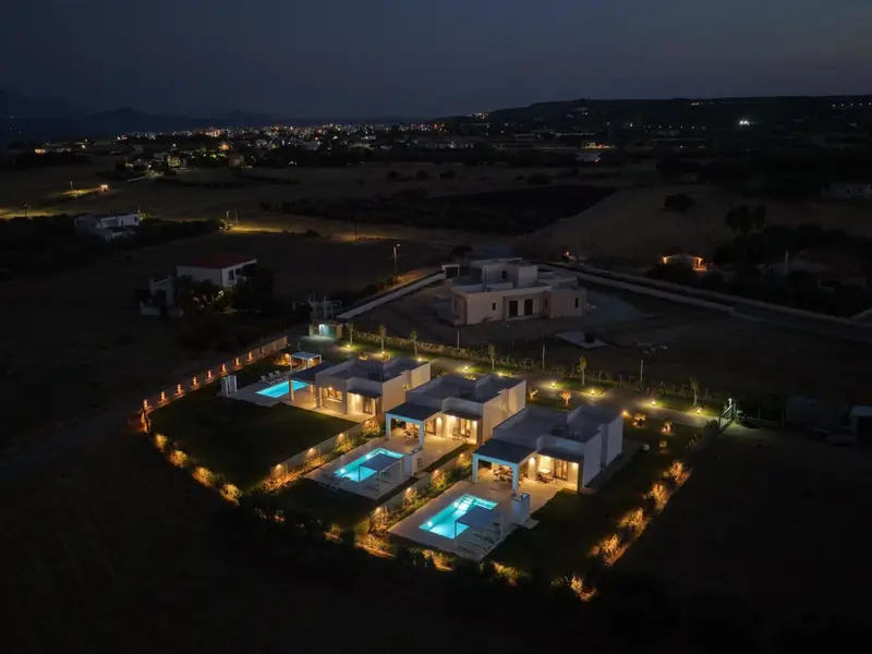 Villa and pool illuminated at night