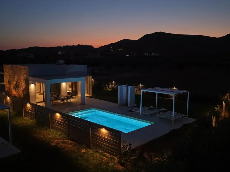 Evening view of the villa with the pool lit