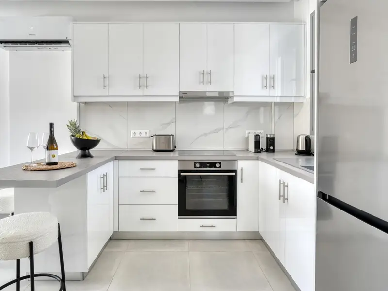 Kitchen with fridge, oven and kitchenware