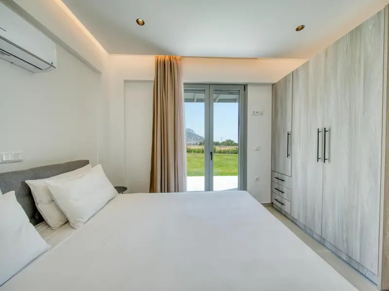 Double bed with wardrobes and terrace doors