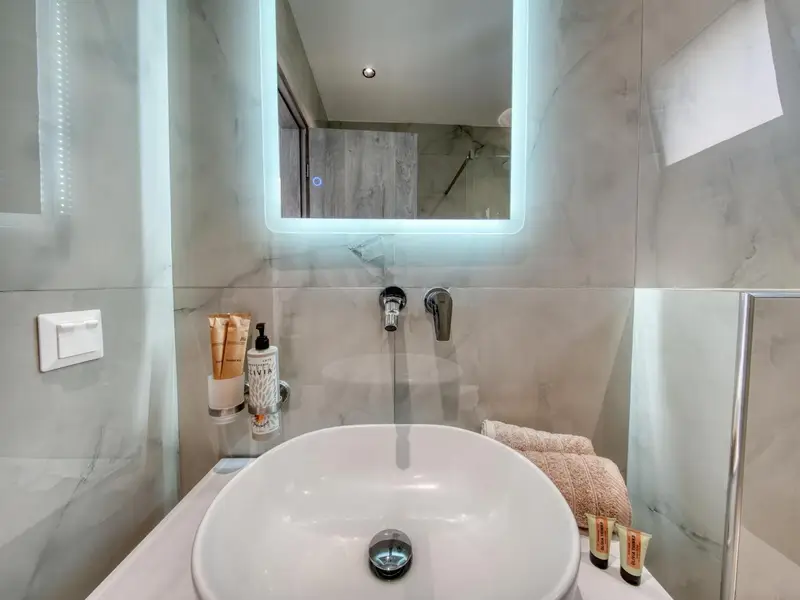 Bathroom vanity with backlit mirror