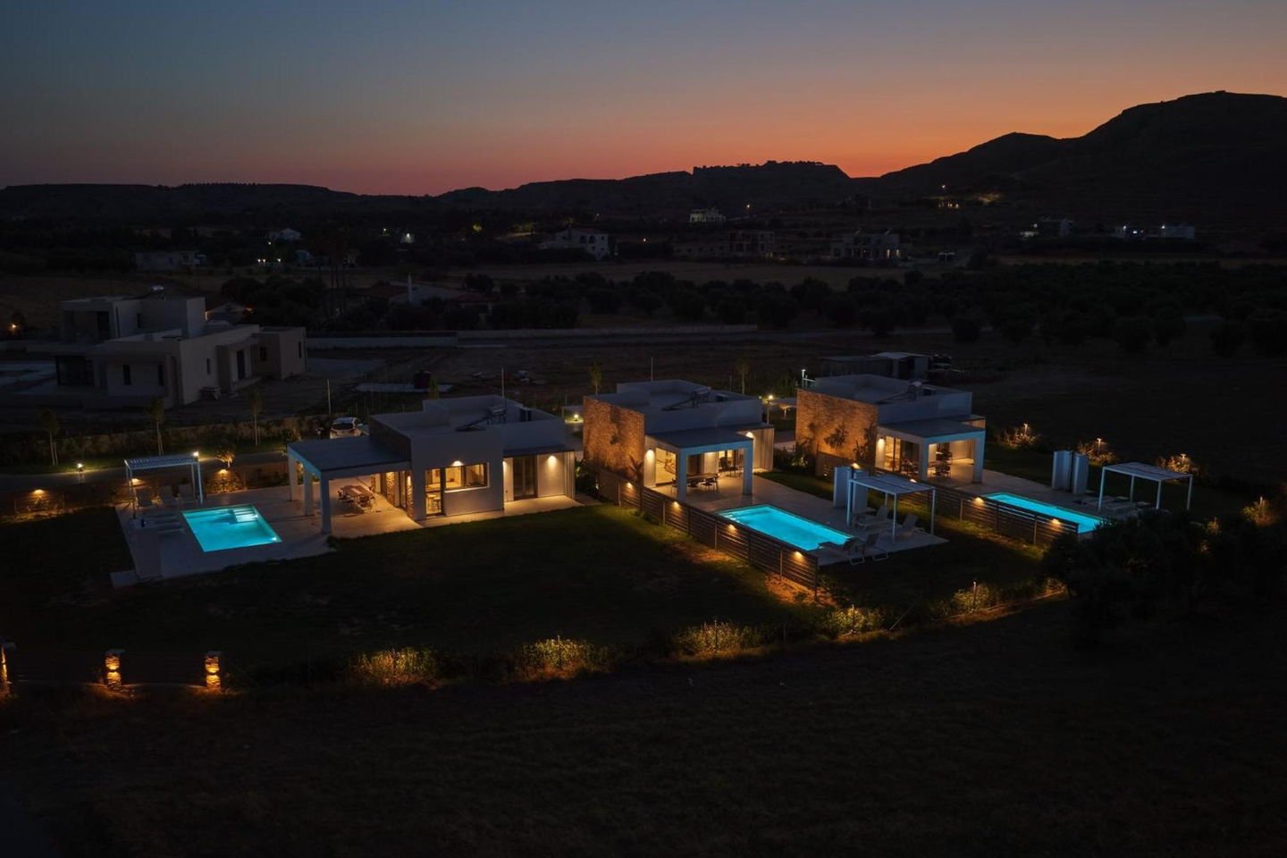 The three villas and their pools at sunset