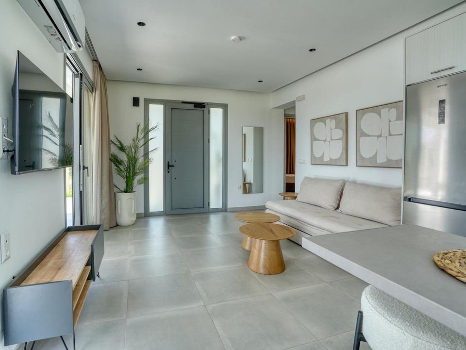 Open-plan living room, dining table and kitchen island